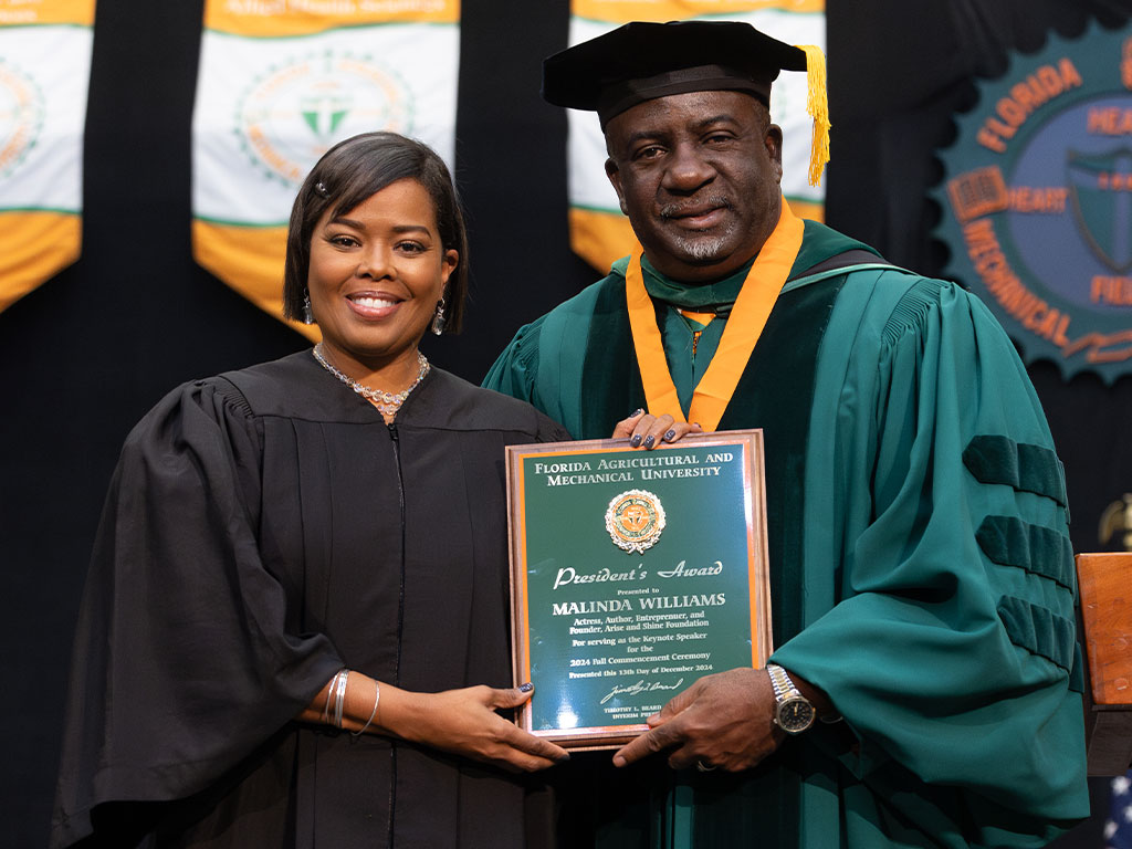 Malinda Williams, actress, author and founder of the Arise And Shine Foundation, Inc. receives recognition from Florida A&M University Interim President Timothy Beard for her service as the commencement speaker for the Florida A&M University Fall 2024 Commencement Ceremony held Friday, Dec. 13 in Tallahassee, Fla.