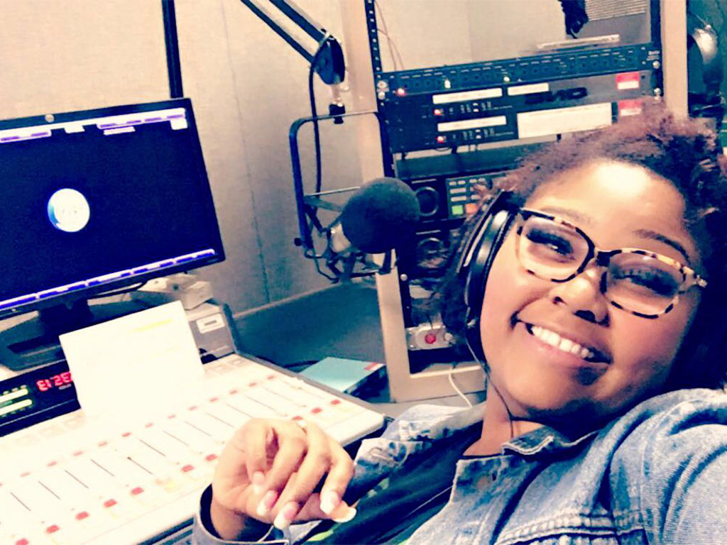 Nadia Sharís Felder, a former WANM 90.5 FM student broadcaster, smiles inside the station's studio during her time at Florida A&M University. Felder was involved with the station from 2015 to 2018, gaining hands-on broadcasting experience that helped her find her professional voice.
