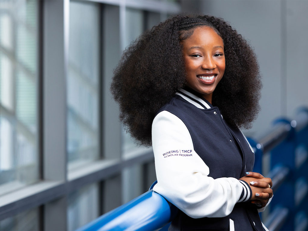 Nevaeh Green posing in her Boeing varsity jackson
