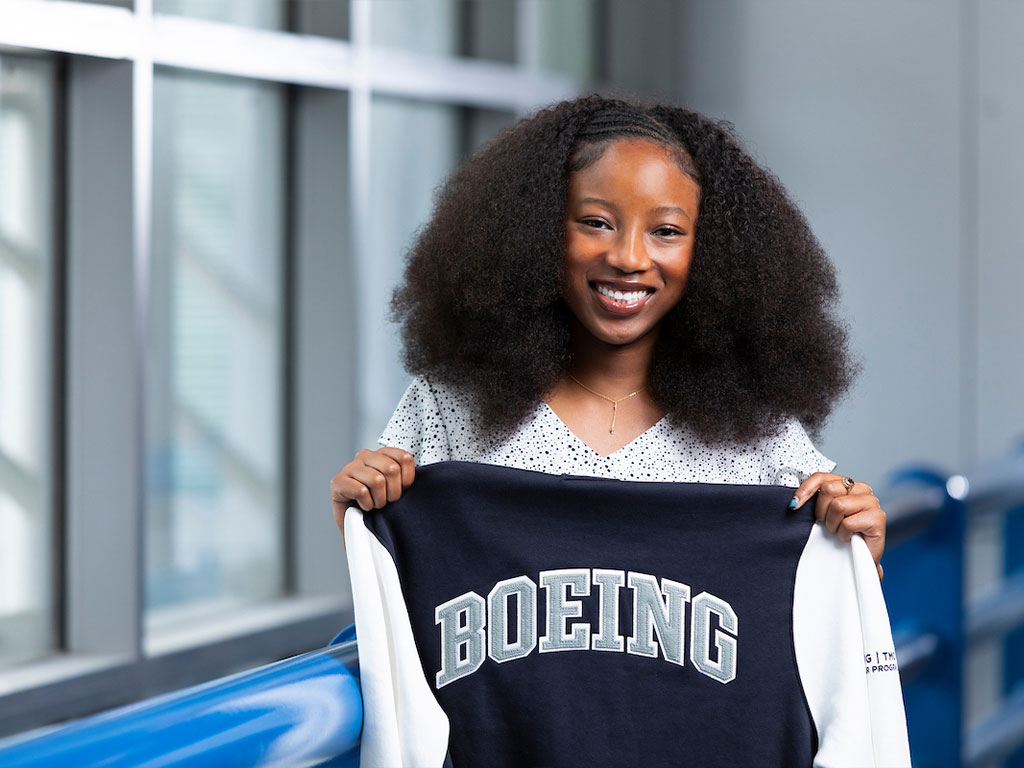 Nevaeh Green holding a Boeing TMCF varsity jacket