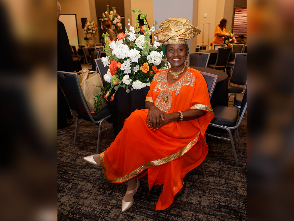 A guest showcases Rattler pride in an elegant orange ensemble with gold detailing and a coordinating headwrap during the Florida A&M University School of Nursing’s 90th anniversary commemorative gala. (Photo Courtesy: Steve Byrum)