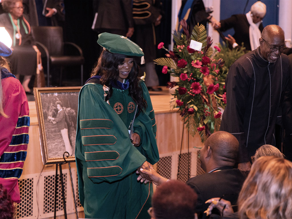 President Marva Johnson greets guests at the service of Dr. Castell Bryant