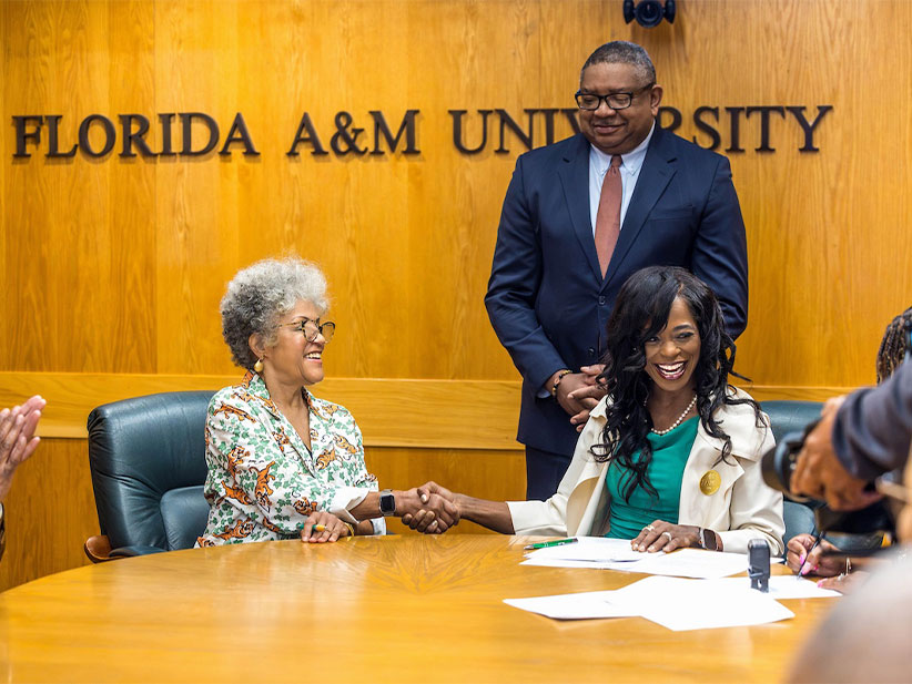 Celeste Hart and President Marva Johnson handshake