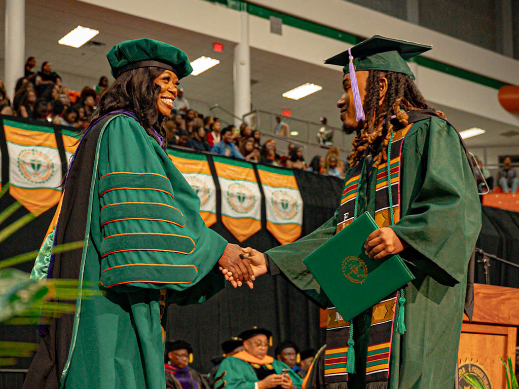 President Johnson greets graduates.