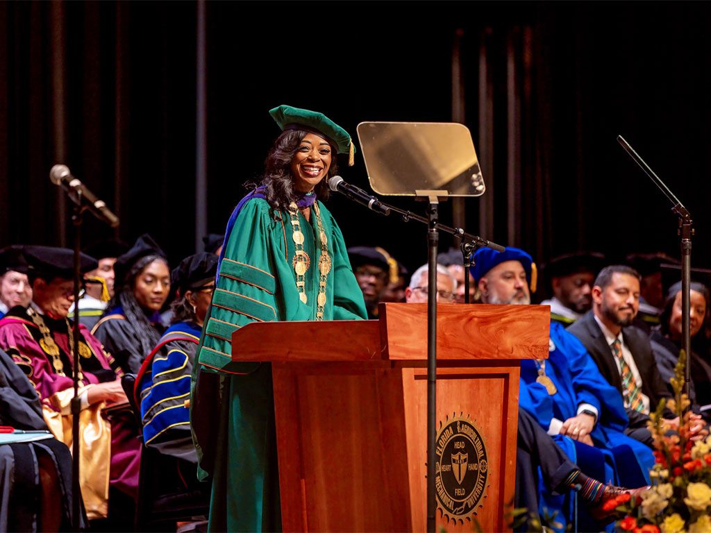 President Marva B. Johnson, J.D. smiling during her investiture as she acknowledges those who supported her.