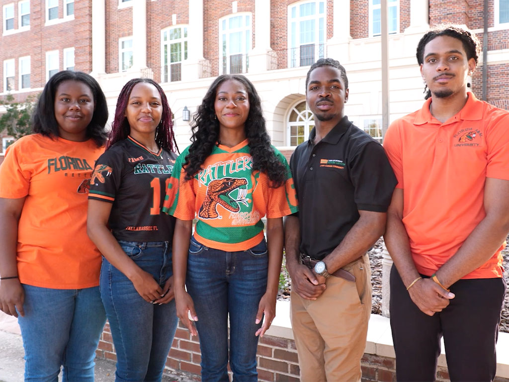 FAMU Students In FAMU apparel posed in front of Lee Hall.