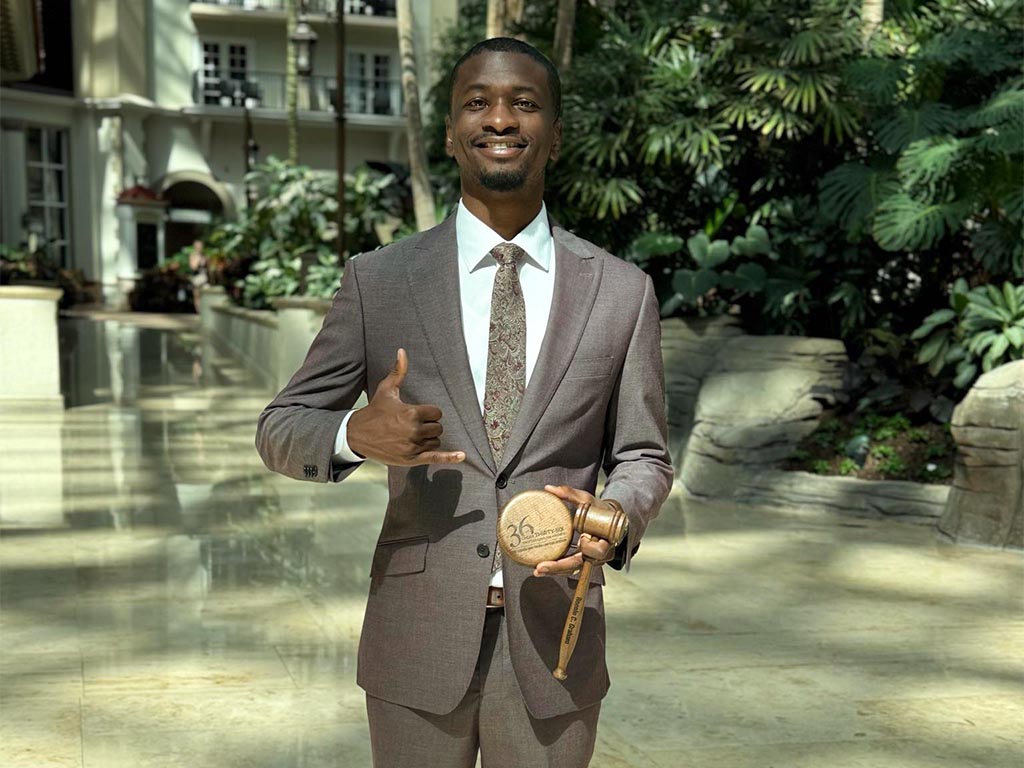 Ronnie Graham holds a gavel in honor of officially becoming a lawyer