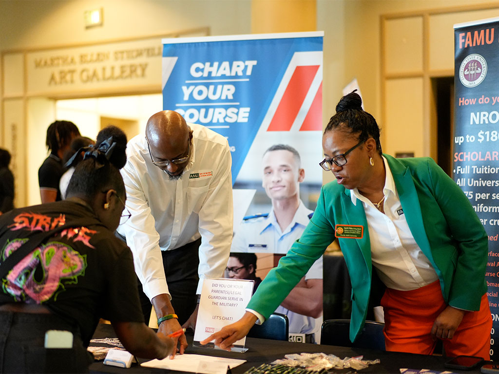 FAMU representatives assist a prospective student during a recruitment event, providing information about scholarship opportunities, academic programs and pathways to enrollment.