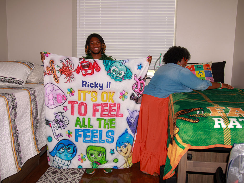 Ricky II holds up his Inside Out blanket