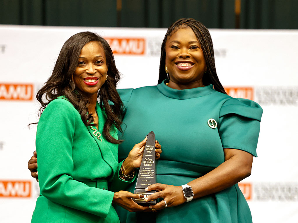 Dr. Brandi Fedrick-Tatum presenting Roshell Rinkins with the Together in Excellence Award The Together in Excellence Award was presented to Zachary and Roshell Rinkins