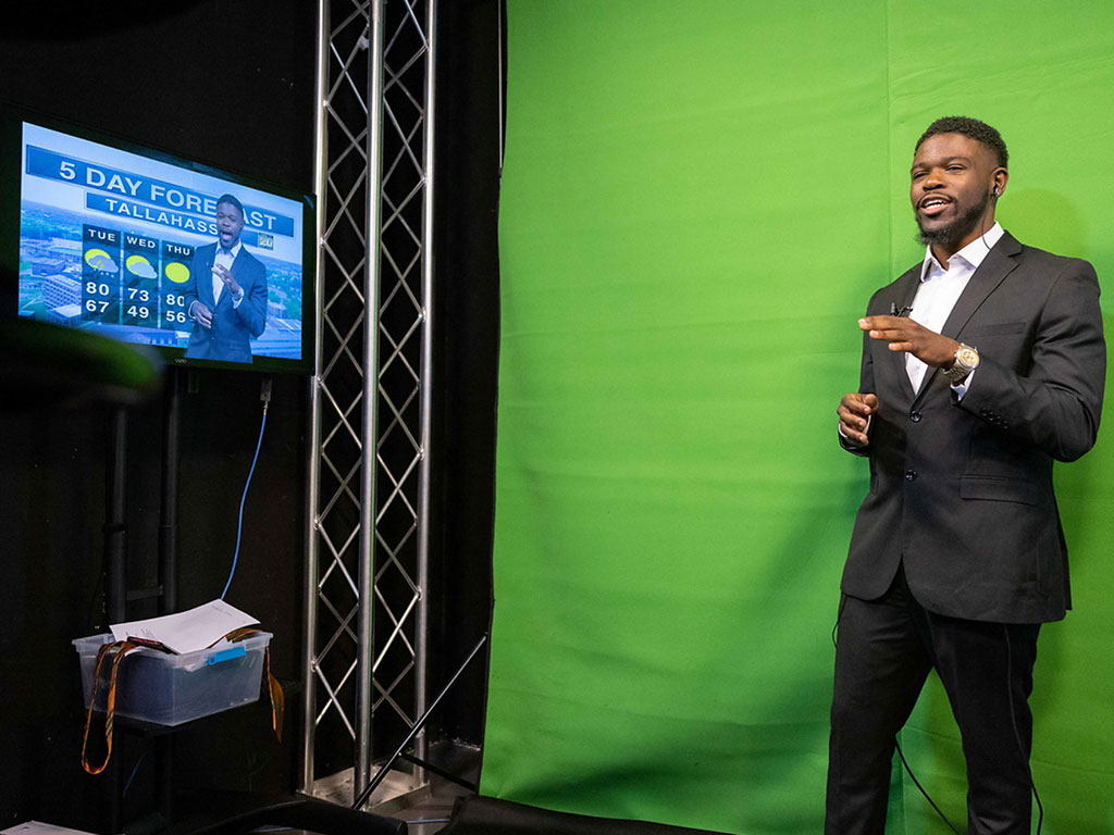 An SJGC student gains hands-on experience in front of the green screen, building practical skills for a future career in broadcast media. (Photo courtesy: FAMU Communications)