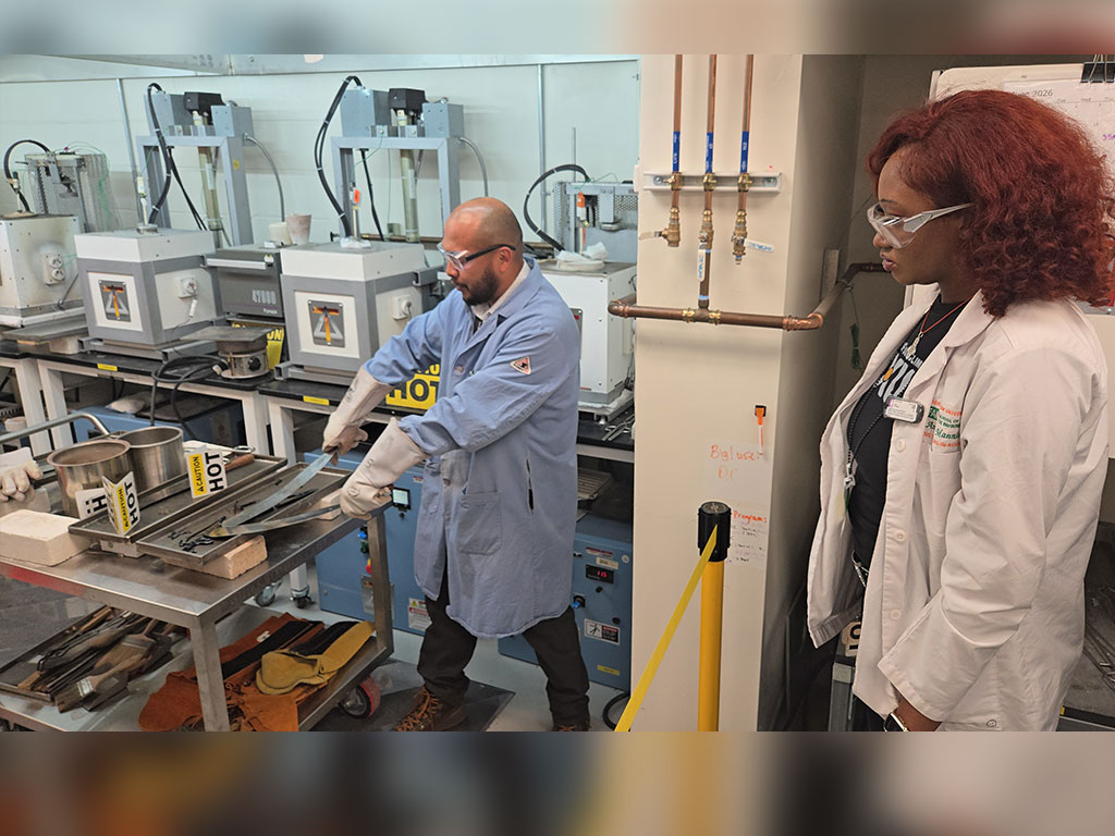 Senior environmental science major Anna D. Manning observes a live research demonstration during a tour of Pacific Northwest National Laboratory (PNNL), where scientists showcased advanced materials testing and laboratory techniques that support energy innovation and national security research. (Photo courtesy of Joel Blount.)