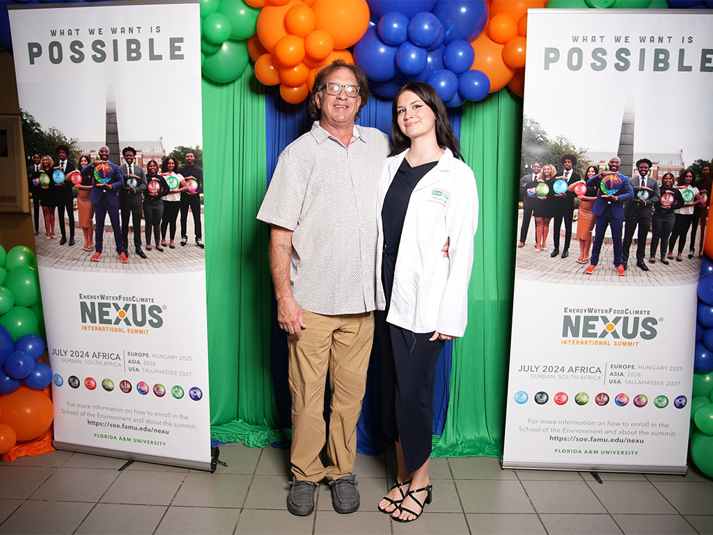 A Florida A&M University School of the Environment student poses with a guest during the White Coat and Greening Ceremony on Sept. 18. Photo courtesy of Ernest Nelfrard.