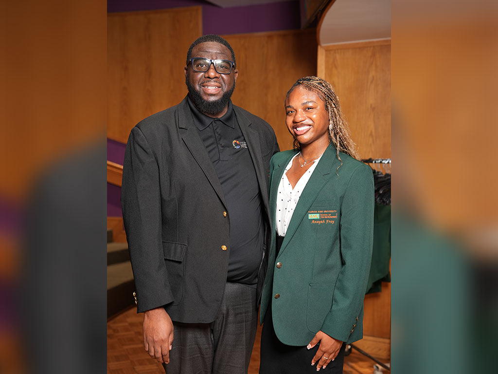 Joel Blount, Ph.D., poses with a Florida A&M University School of the Environment student following the White Coat and Greening Ceremony on Sept. 18.