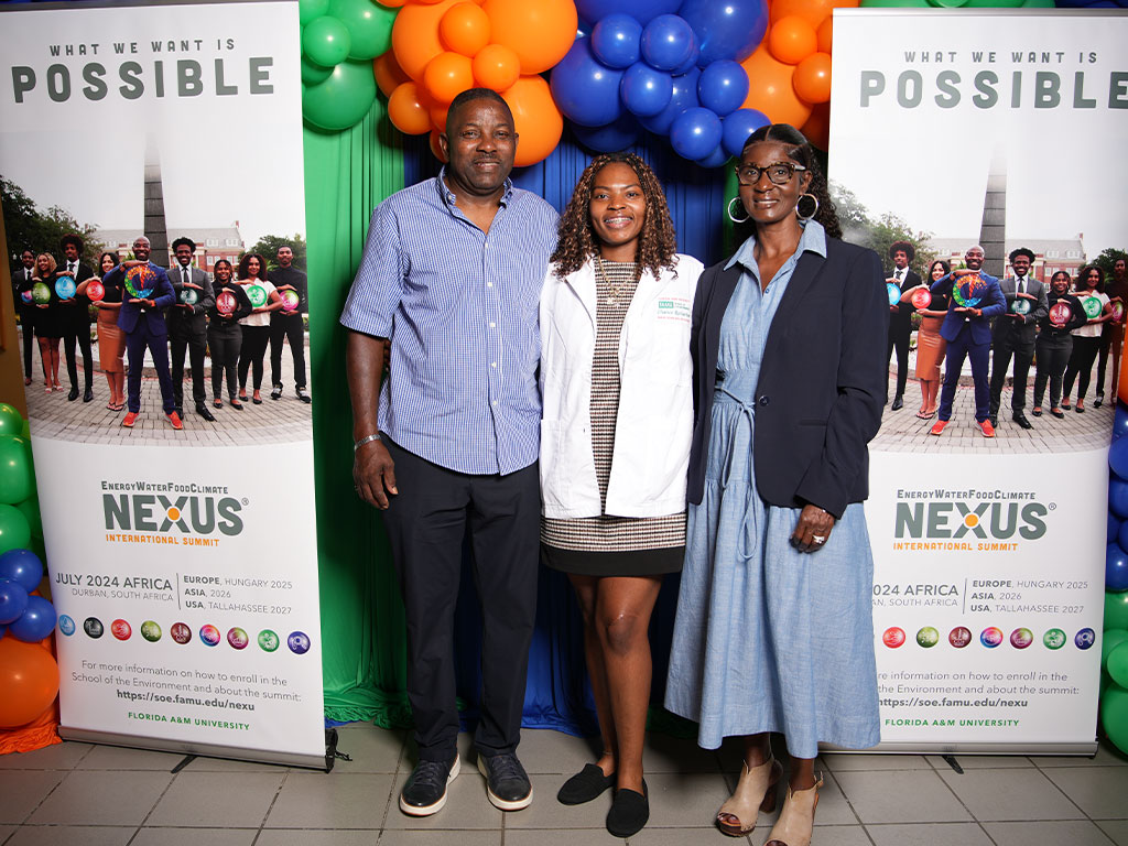 An incoming Nexus Scholar celebrates receiving her white coat alongside family members during the School of the Environment’s White Coat and Greening Ceremony. The milestone marks the beginning of her academic and research experience in the Nexus Scholars-in-Residence Program.