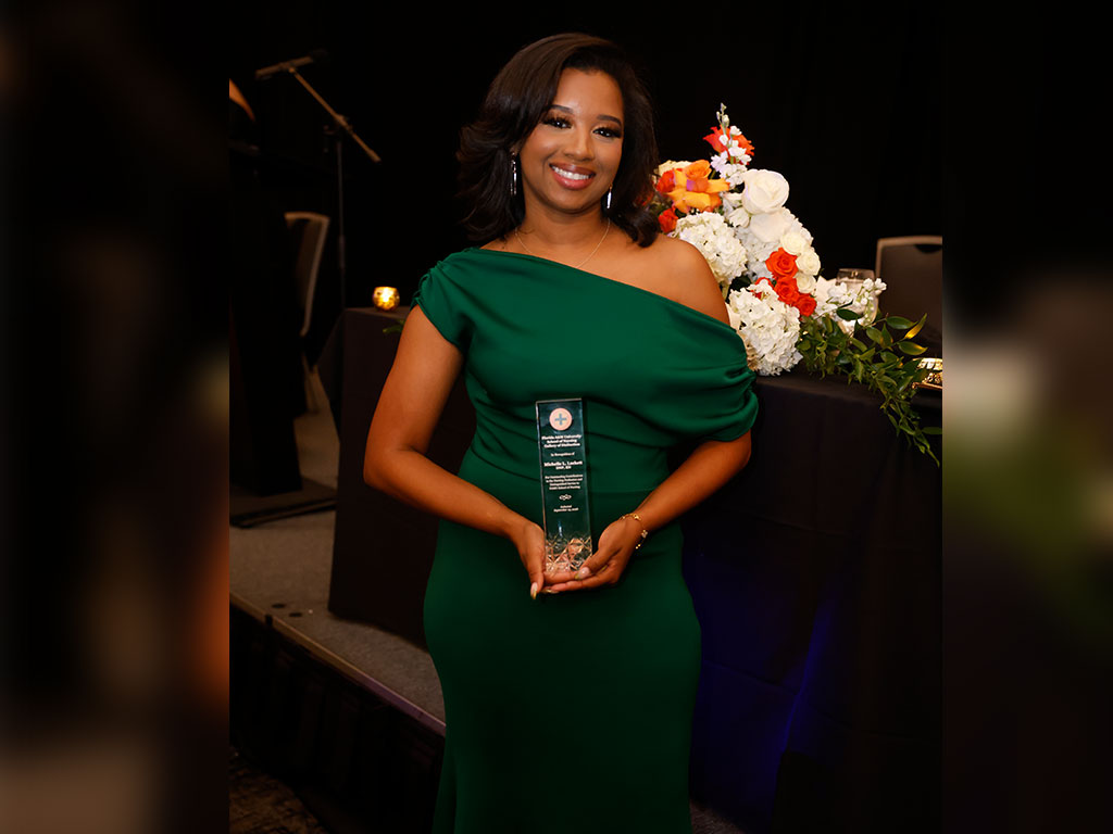 Michelle L. Lockett, a 2006 FAMU graduate and 2026 School of Nursing Gallery of Distinction inductee, displays her award during the School of Nursing’s 90th anniversary commemorative gala. (Photo Courtesy: Steve Byrum)