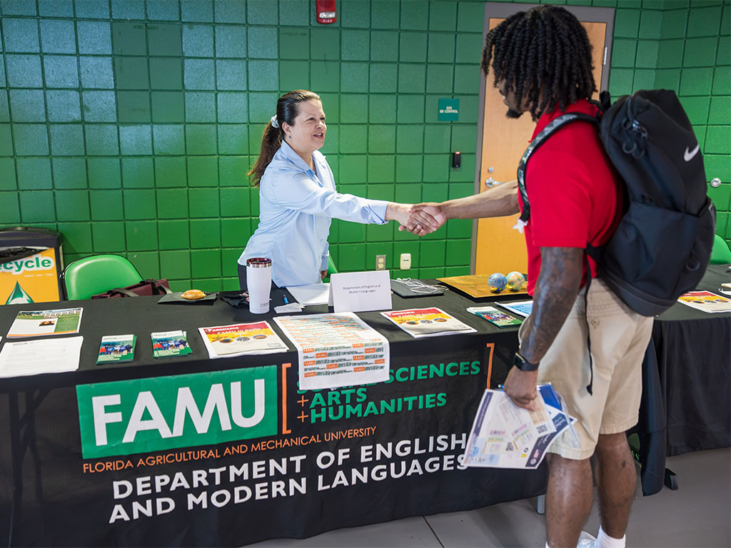 A Florida A&M University student speaks with a representative from the Department of English and Modern Languages during the Study Abroad Fair, where students explored international education opportunities and resources.