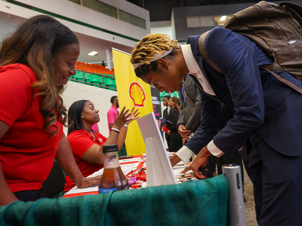 A FAMU student connects with representatives from Shell during a Career and Internship Expo at the Al Lawson Multipurpose Center. The Expo provides students with opportunities to engage directly with employers and explore potential internships and career pathways. (Photo courtesy FAMU Communications)