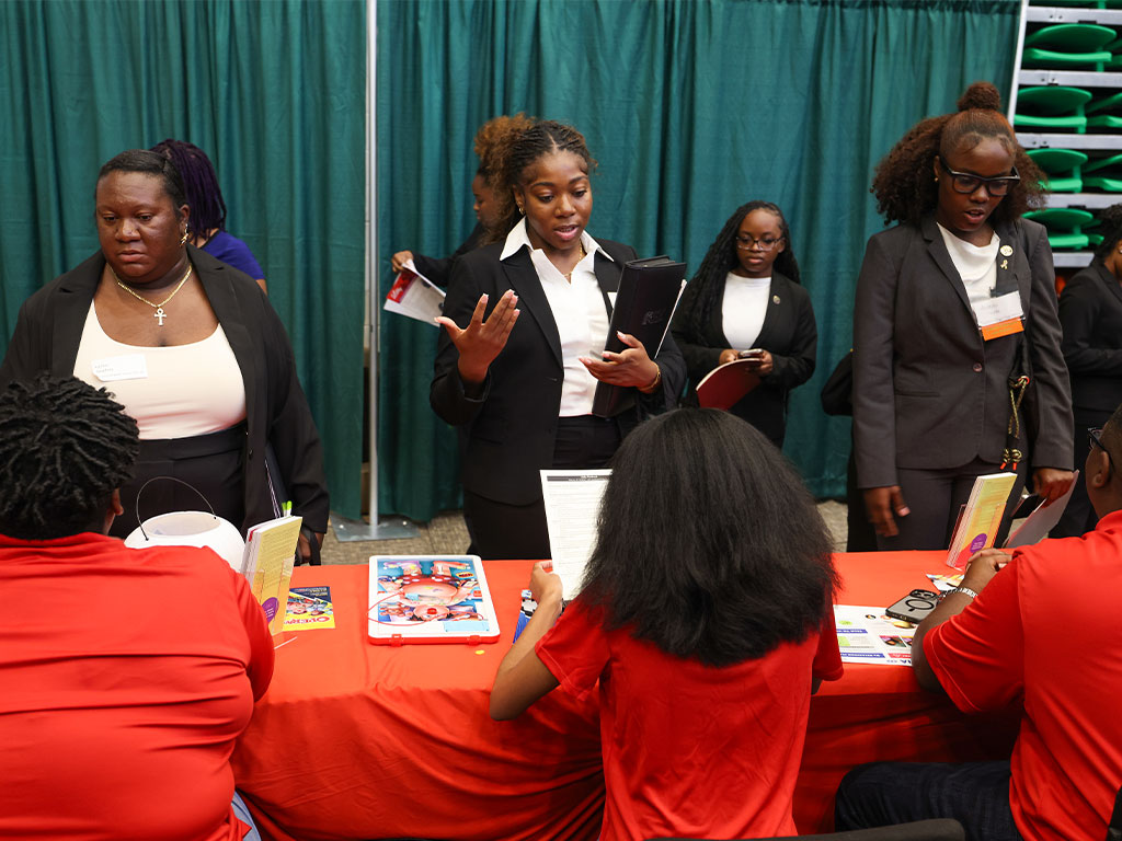 FAMU students engage with employer representatives during a Career and Internship Expo at the Al Lawson Multipurpose Center. The Expo provides students with opportunities to network with prospective employers and explore internships and career pathways. (Photo courtesy FAMU Communications)