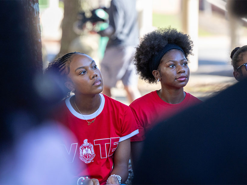 Two greek girls listening intently