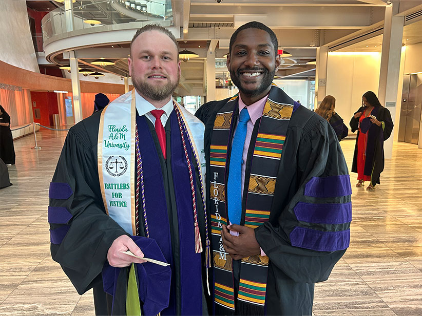 Two young male College of Law graduates