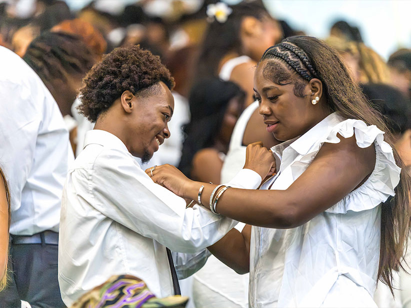 A young man and young lady pinning each other