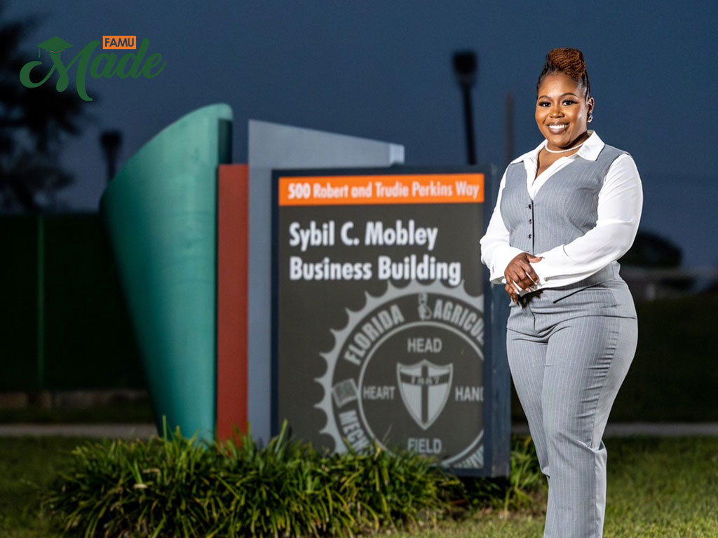 Vanessa standing in front of the SBI sign