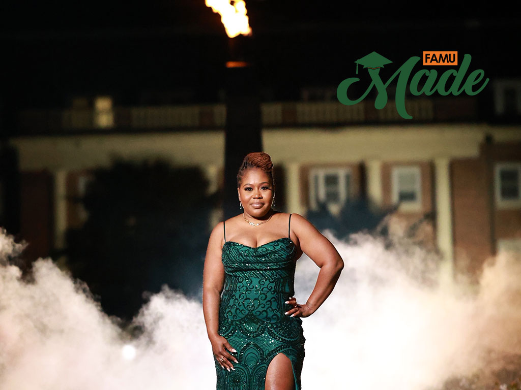 Vanessa P Vanessa in a green ball gown standing in front of the eternal flame