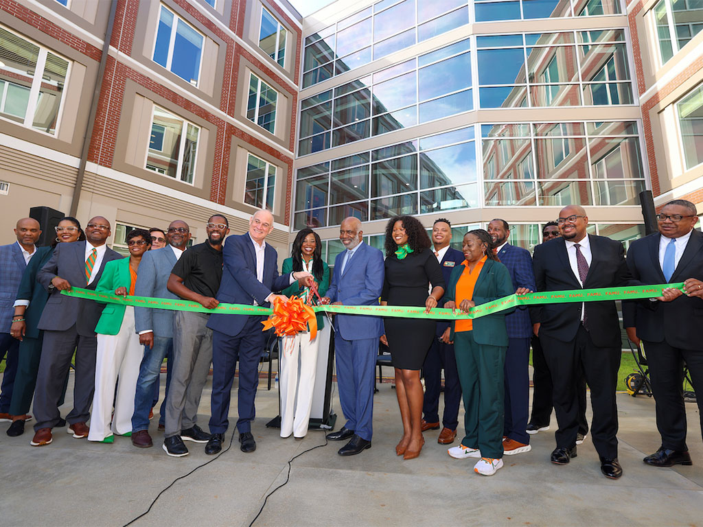 FAMU officials pose for the ribbon cutting of new living facility
