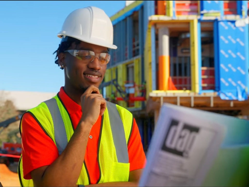 Da’Mari Clayton reviews engineering plans on-site, reflecting his hands-on experience and growing expertise in the field. (Photo Courtesy: Da’Mari Clayton)