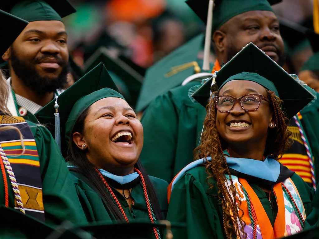 Graduates bursting with laughter. 