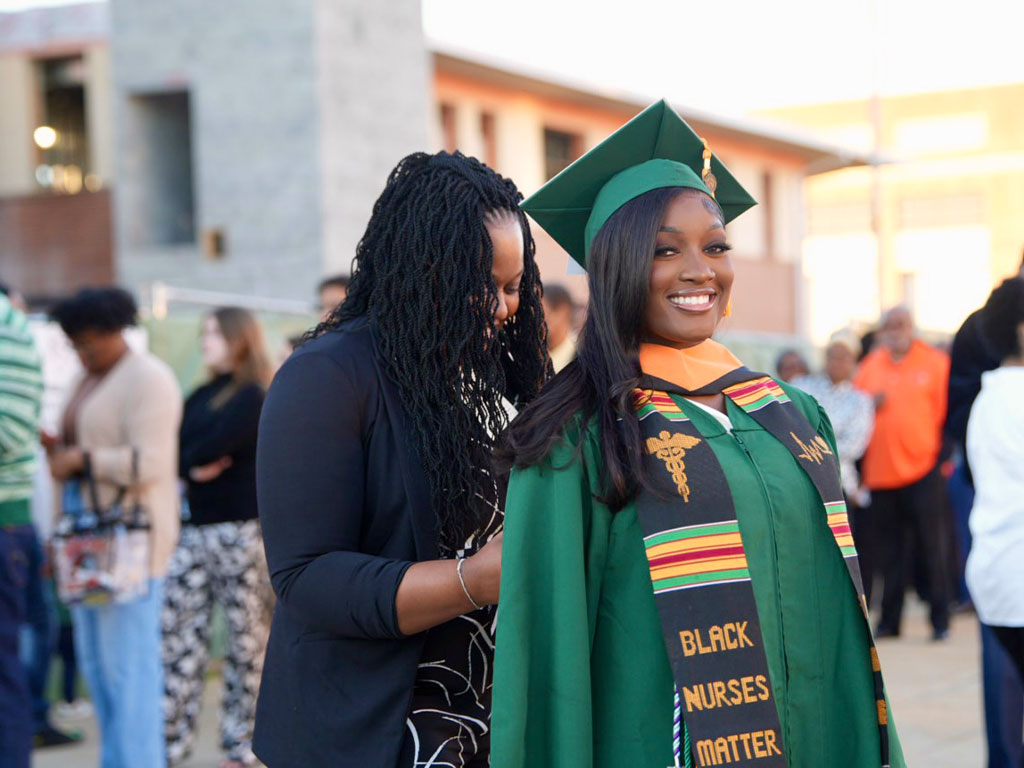 Mother fixing her daughter's stole