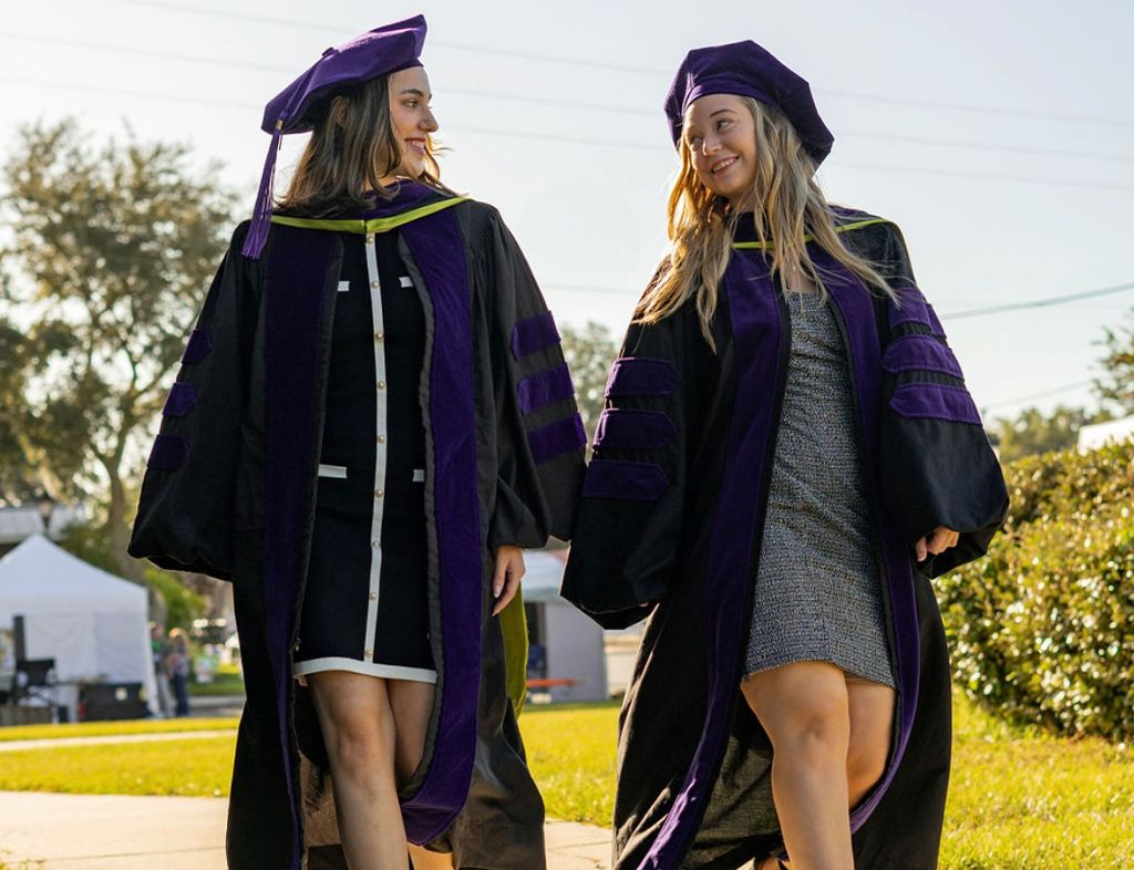 (Left to Right) Christina Lanzilla and Stephanie Maines pose for graduation photos in celebration of completing FAMU College of Law.