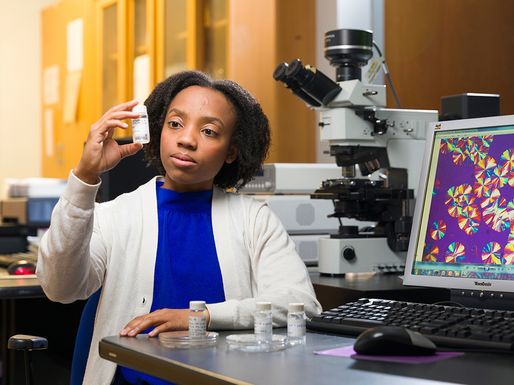 Briona Carswell poses with an on-screen microscopic image of her polymers as well as some samples in the Alamo Lab at FAMU-FSU College of Engineering in Tallahassee, Florida on October 25, 2024. Carswell is the first FAMU graduate student in the new Materials Science & Engineering department.