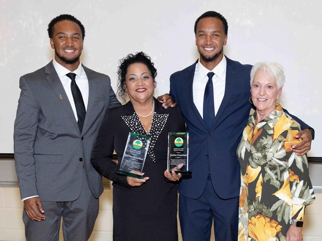 Twins win legacy awards and pose with program leaders 