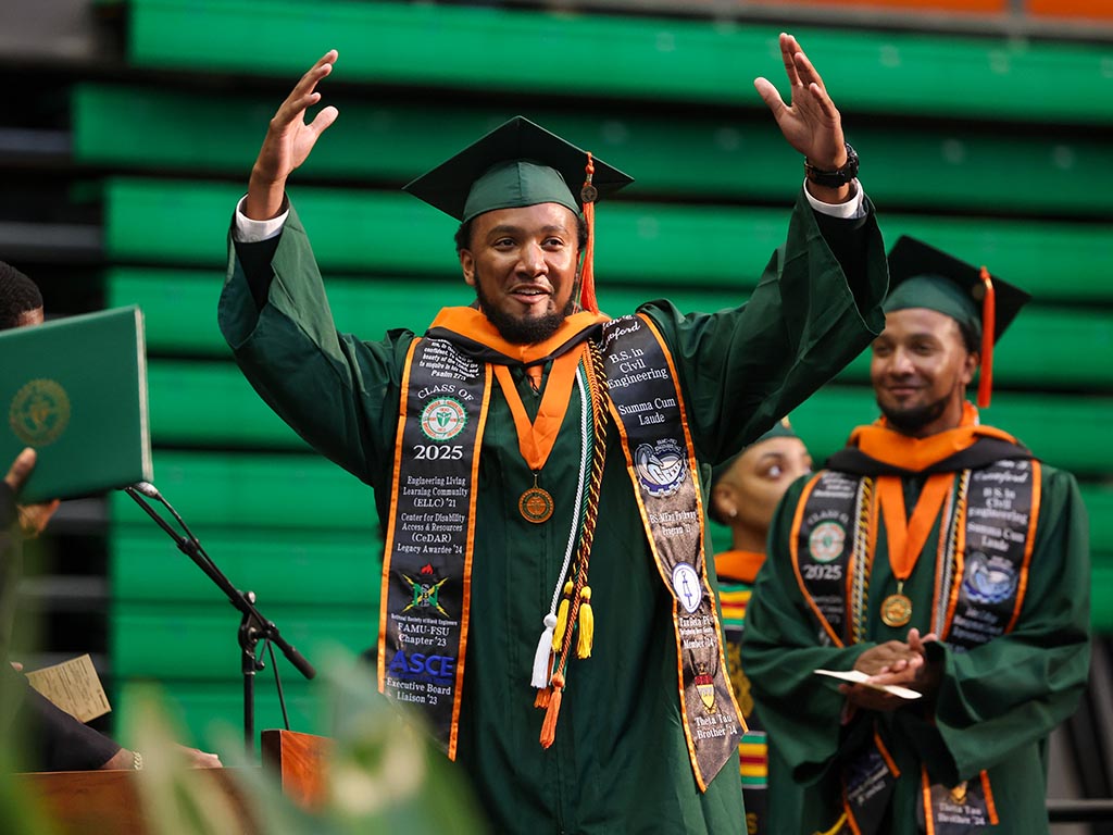 Brothers walk across stage to recieve diploma